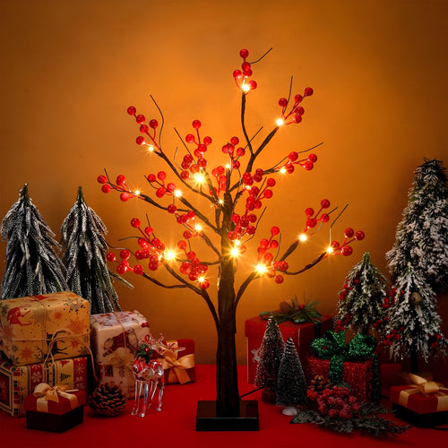 Árbol de mesa iluminado en una composición navideña